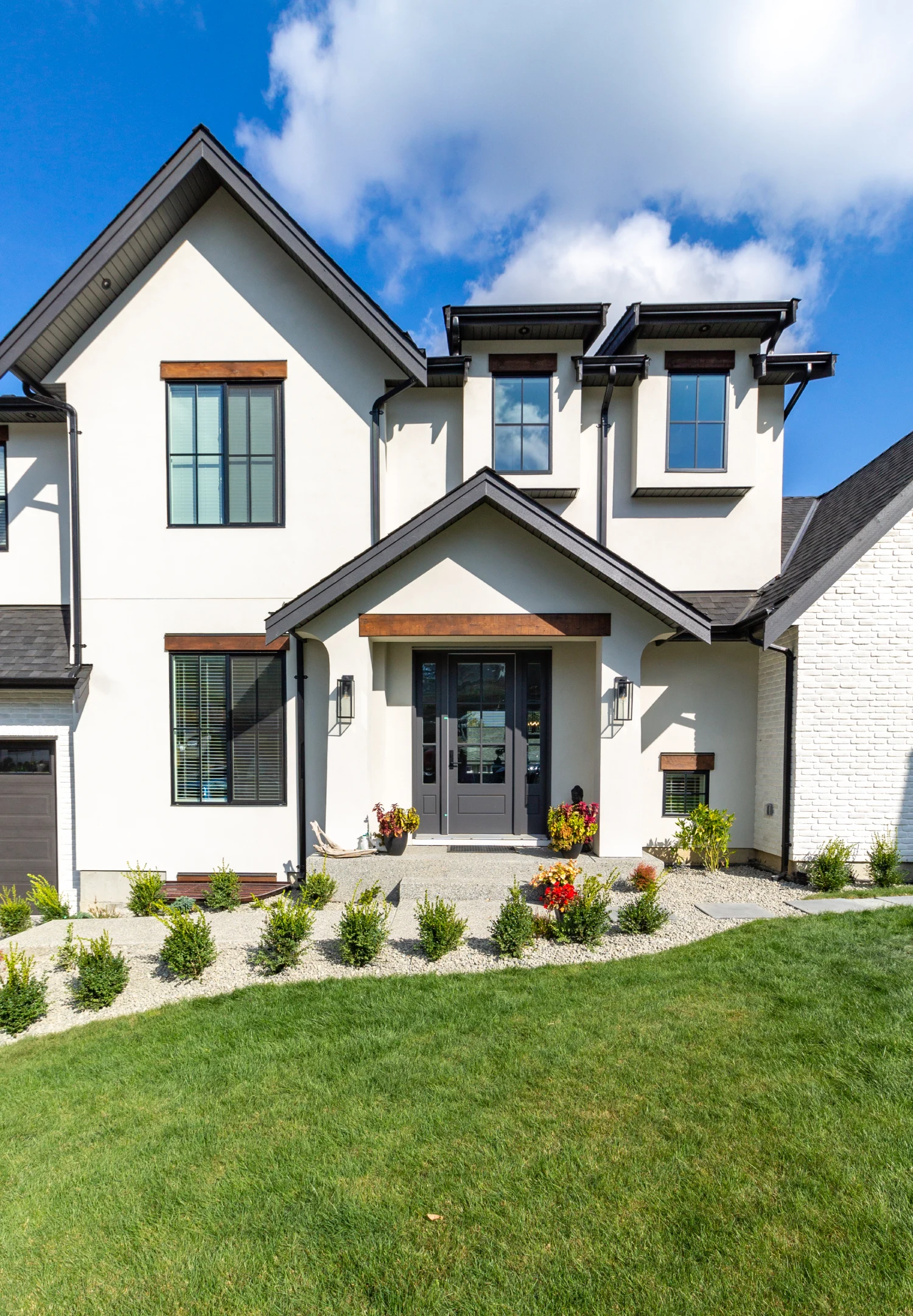 Modern two-story house with manicured lawn.