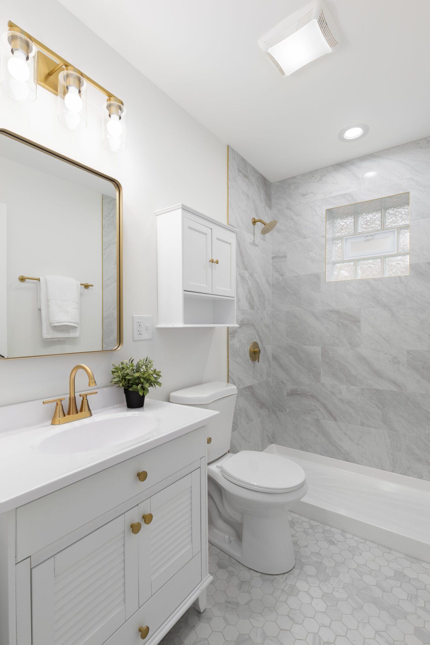 Modern white bathroom with marble shower.