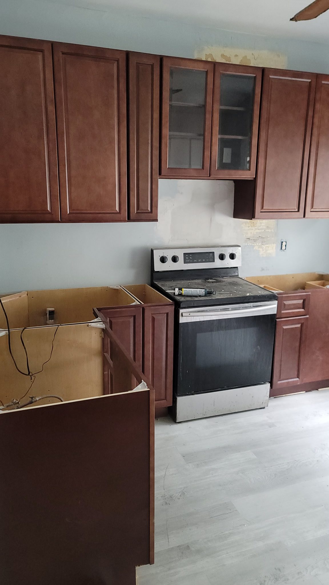 Kitchen under renovation with brown cabinets.