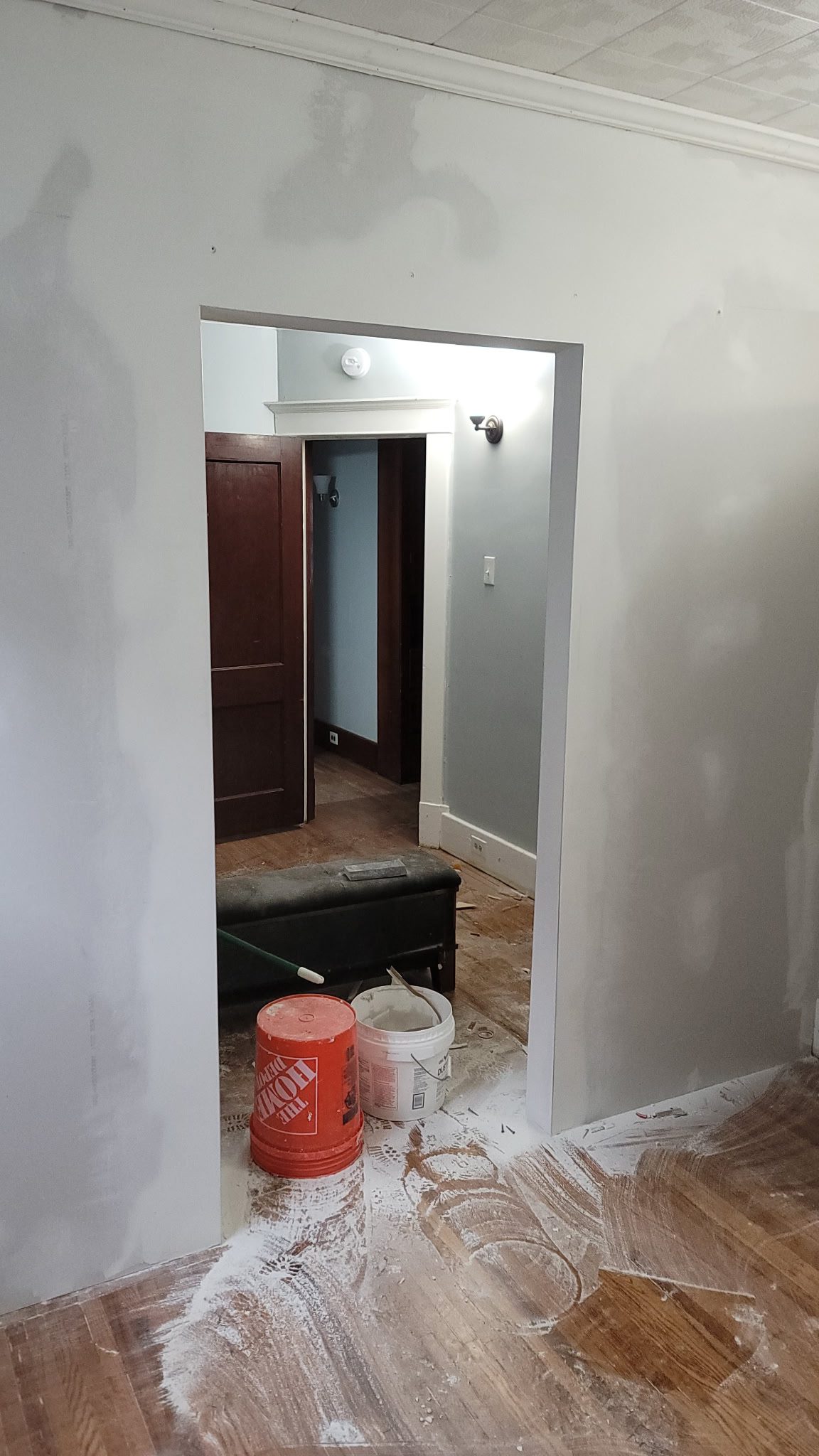 Room under renovation with paint supplies.
