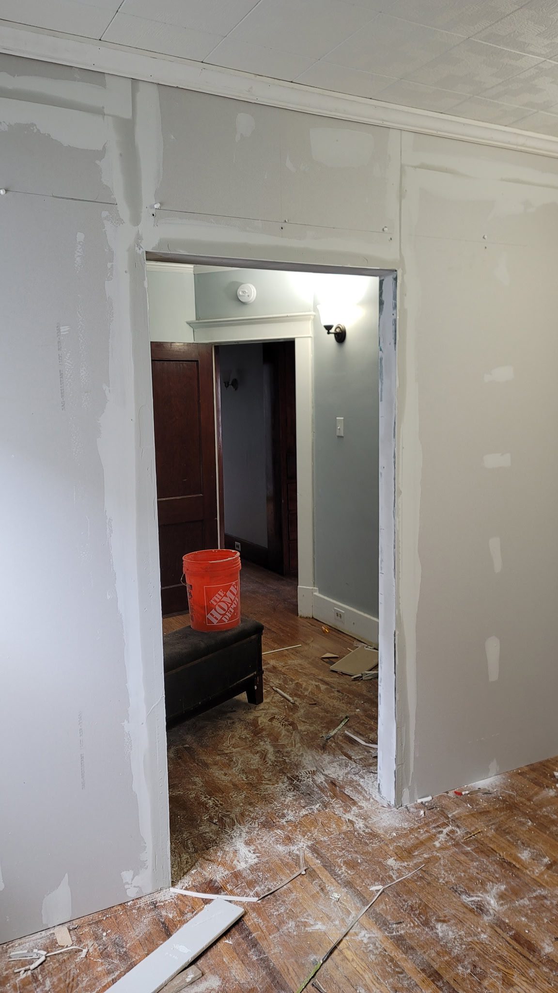Doorway under construction with exposed drywall.