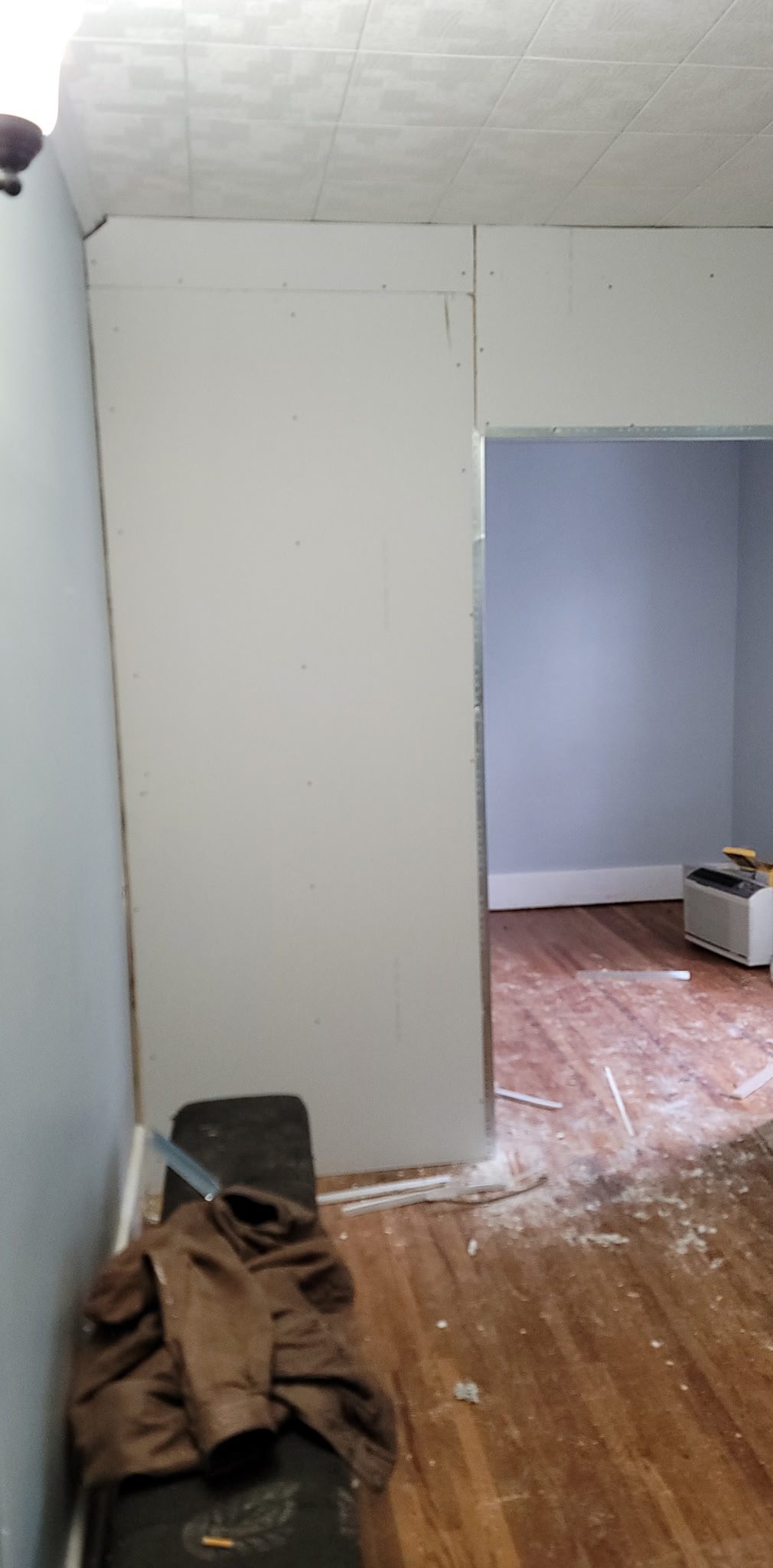 Room under renovation with drywall installation.