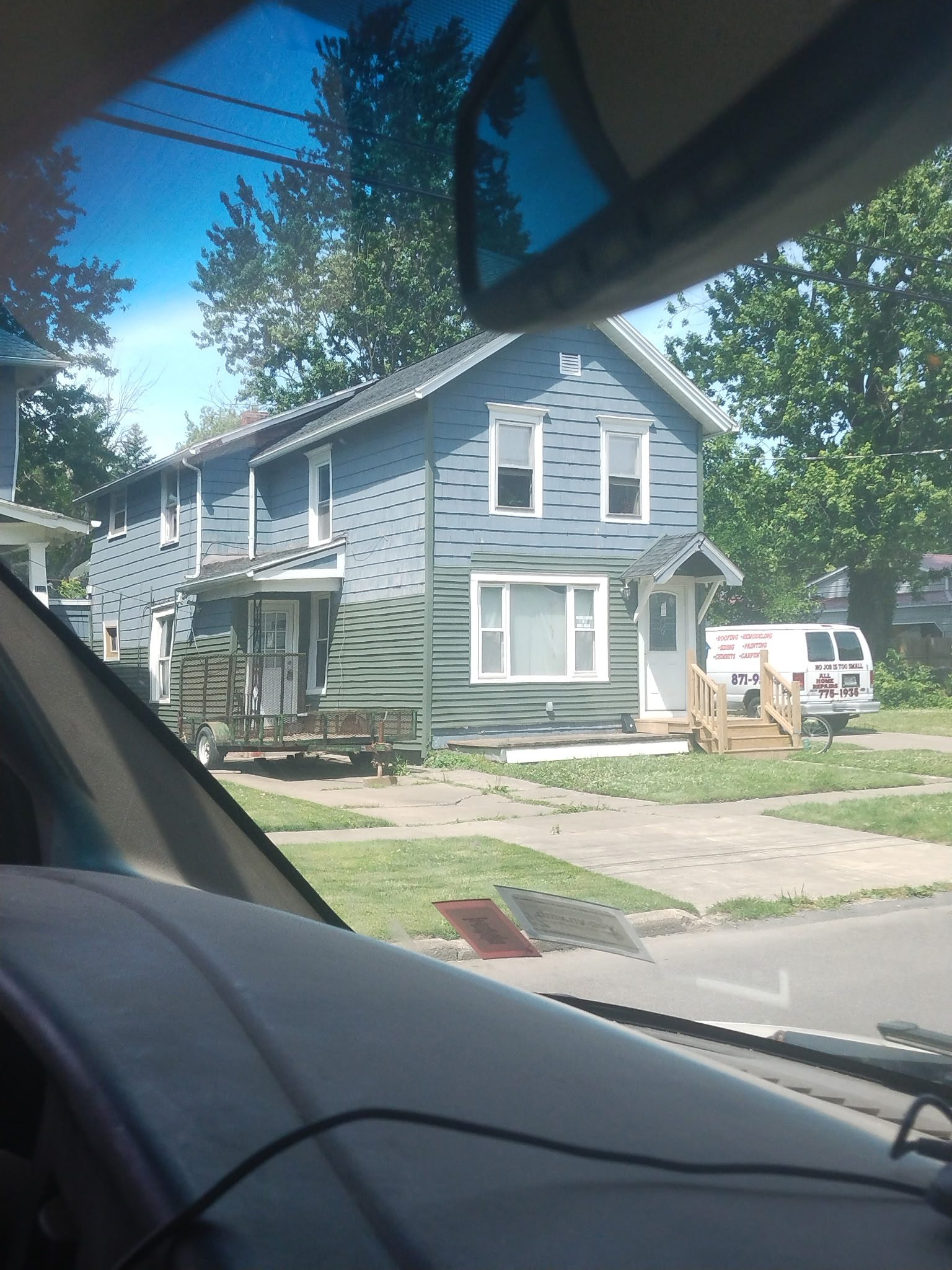 Blue house viewed from car interior.