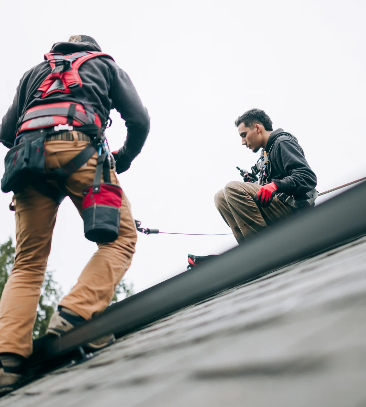 Workers installing safety equipment on roof